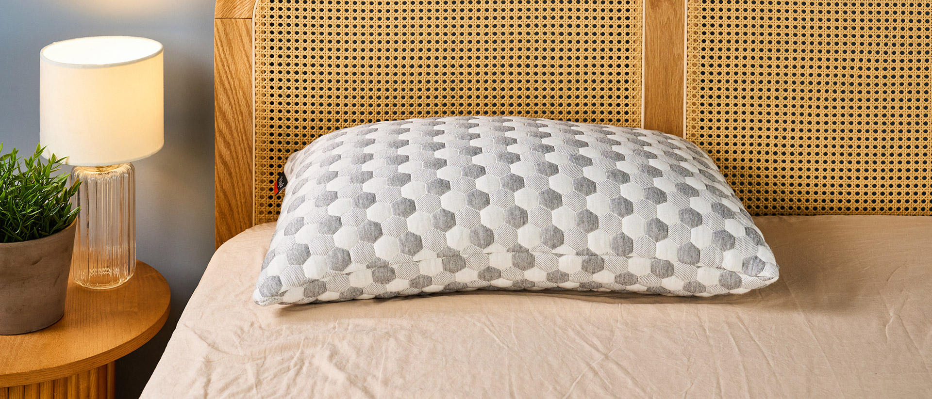 Layla grey and white kapok pillow in a brightly lit room