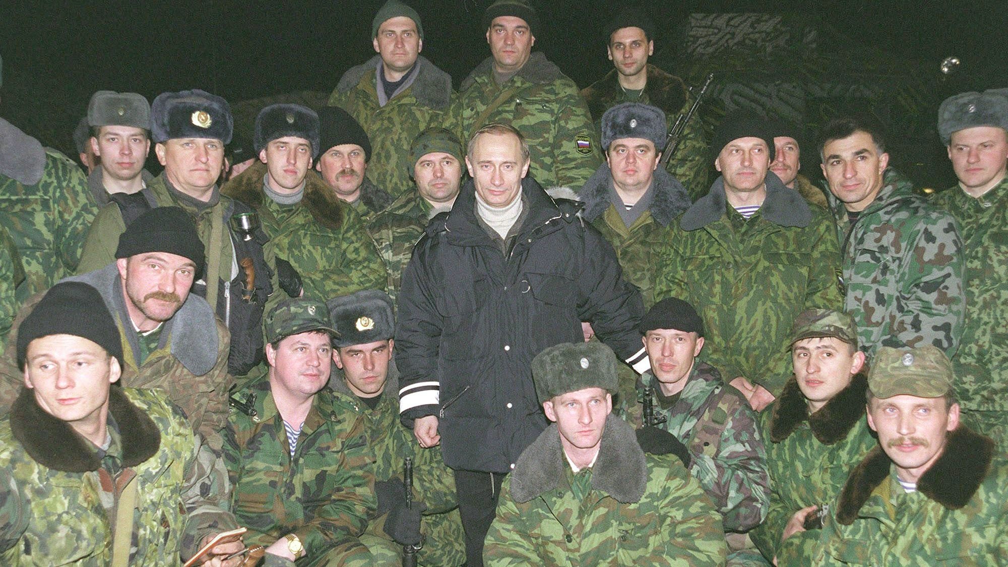 Vladimir Putin pictured with Russian soldiers in camouflage uniforms near Grozny
