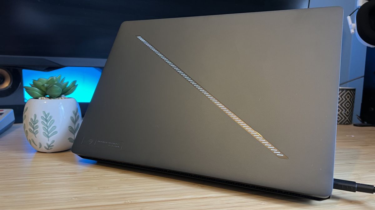 Asus ROG Zephyrus G14 gaming laptop with lid facing camera on a wooden desk