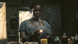 Wunmi Mosaku lighting a match in Sinners