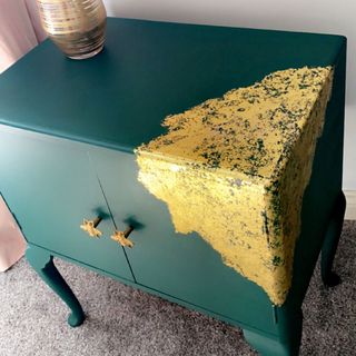 Green upcycled cabinet with gold handles and detail