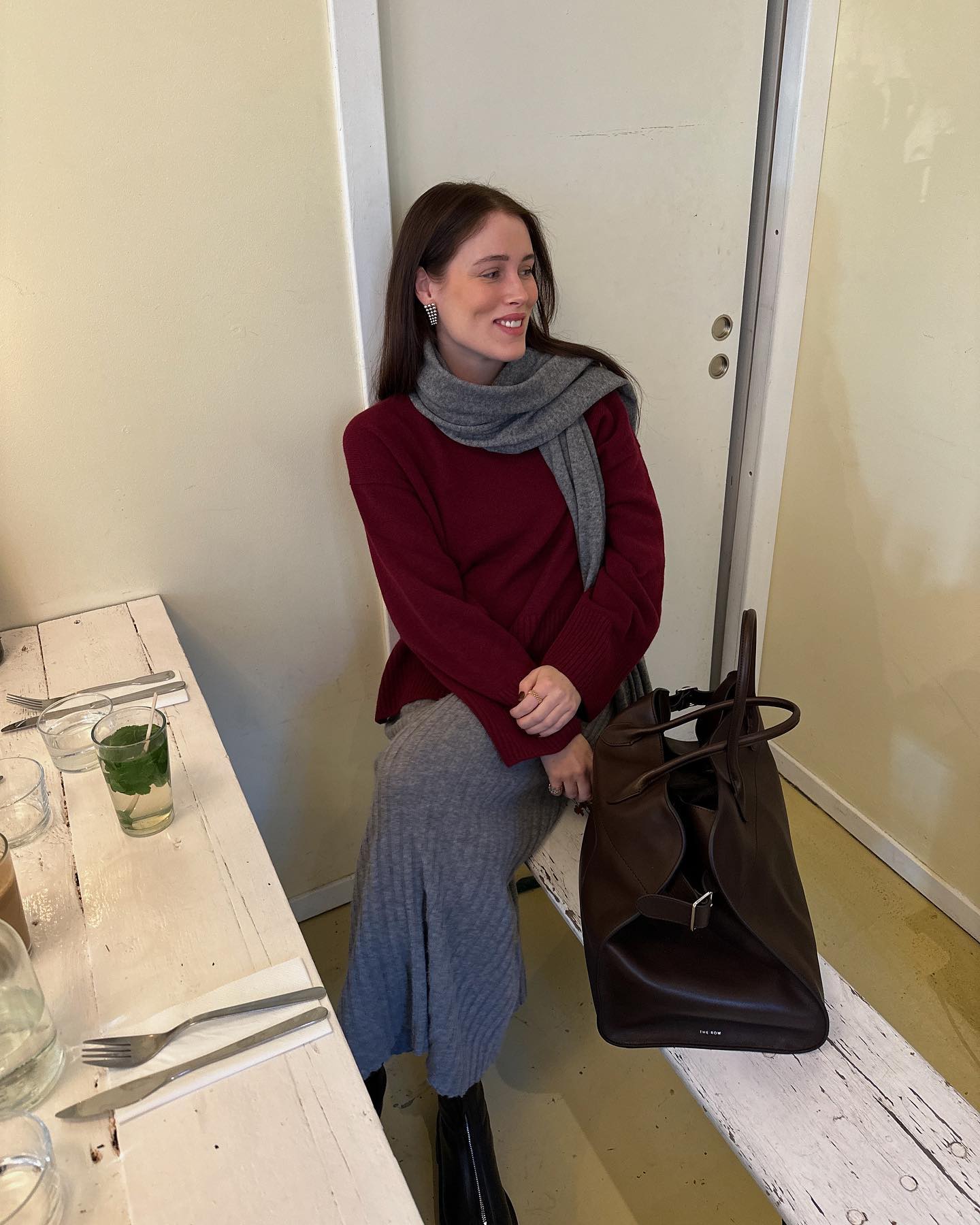 @annabelrosendahl wears a burgundy jumper with a charcoal knitted skirt and scarf