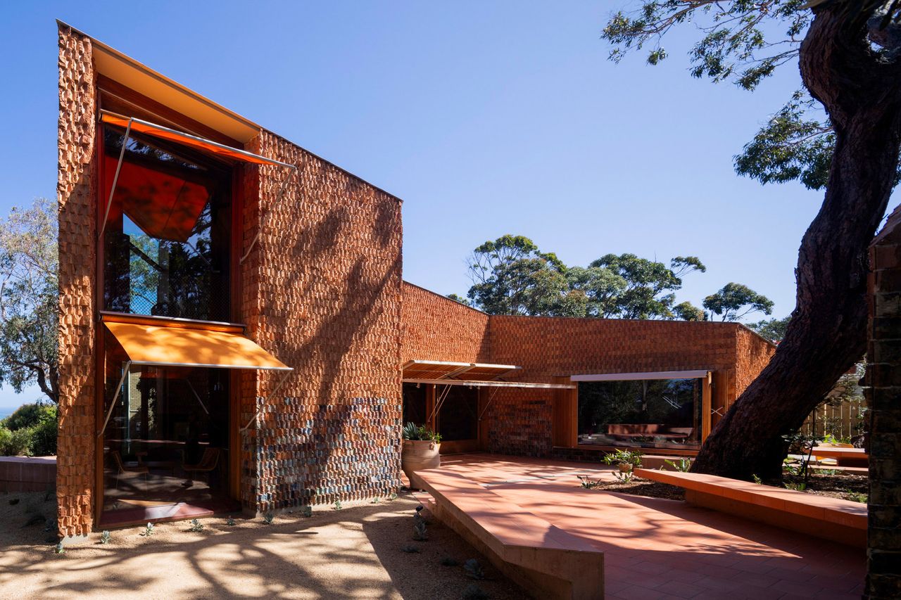 burnt earth beach house hero exterior of terracotta facade