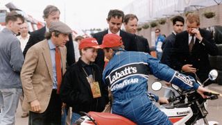 Prince William jokes with a racing driver at the British Grand Prix