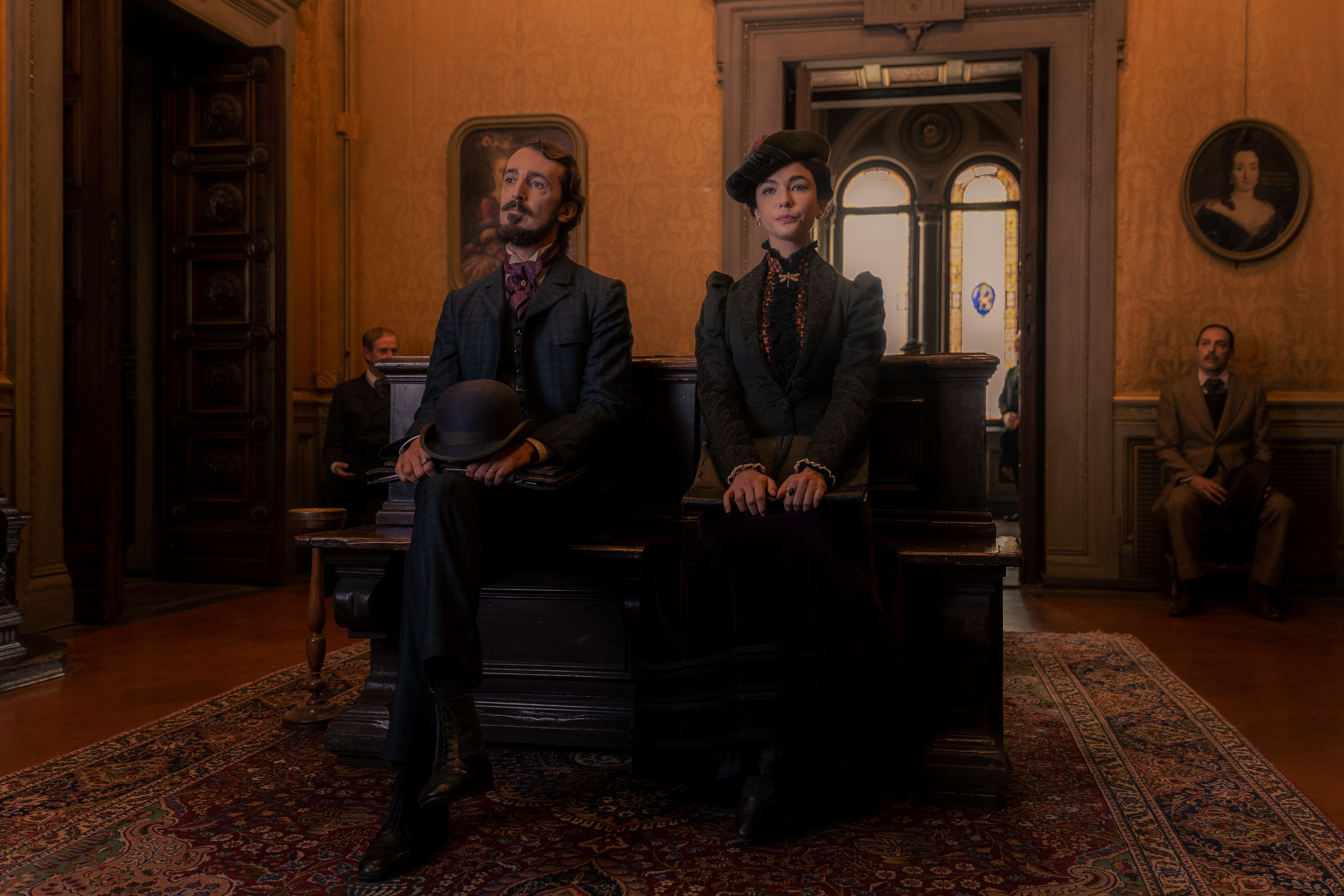 Pier Luigi Pasino and Matilda De Angelis as Enrico and Lidia Poet leaning against a desk