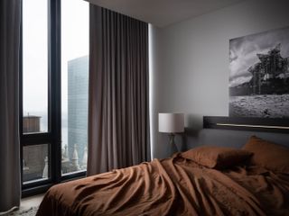 A bedroom with a dark color scheme
