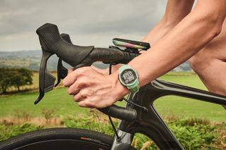 Female cyclist wearing a smartwatch whilst riding