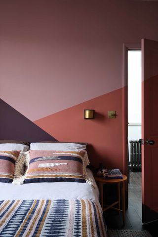 a bedroom with a painted wall instead of a headboard