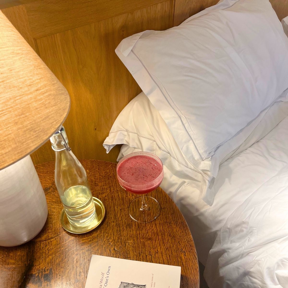 newroad 30 supplement on a bedside table next to white bedding