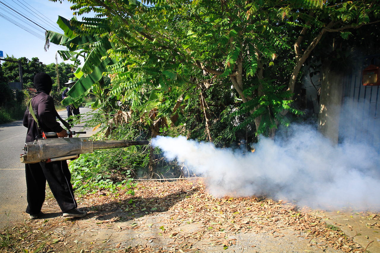 A worker sprays pesticide to kill mosquitoes that carry the Zika virus.