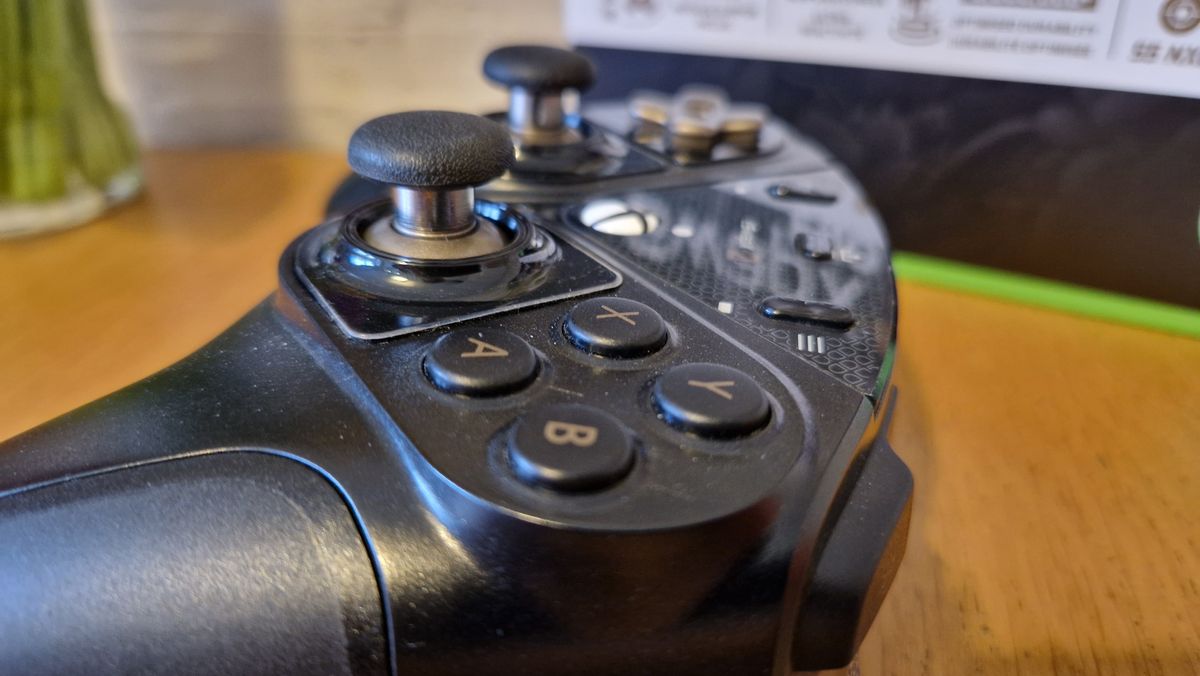 The Thrustmaster eSwap X2 controller on a wooden surface