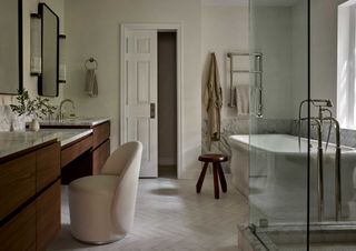 a neutral grey bathroom with a bathtub and vanity