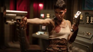 A bloody Sofia Boutella takes aim with her pistols in Rebel Moon - Part Two: The Scargiver.