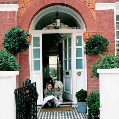 exterior of house with red brick wall and white door