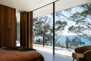 The main bedroom has a private terrace and spectacular views at Tinderbox House by Studio Ilk Architecture