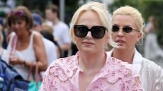 rebel wilson wearing a pink dress and sunglasses