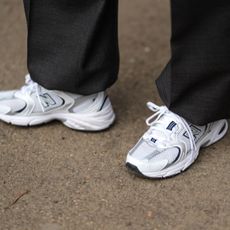 A guest wears New Balance sneakers shoes , outside Dolce & Gabbana, during the Milan Fashion Week Menswear Fall/Winter 2025-2026 on January 18, 2025 in Milan, Italy. (Photo by Edward Berthelot/Getty Images)