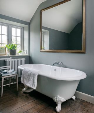 Gray bathroom with roll top bath in country house in Wiltshire
