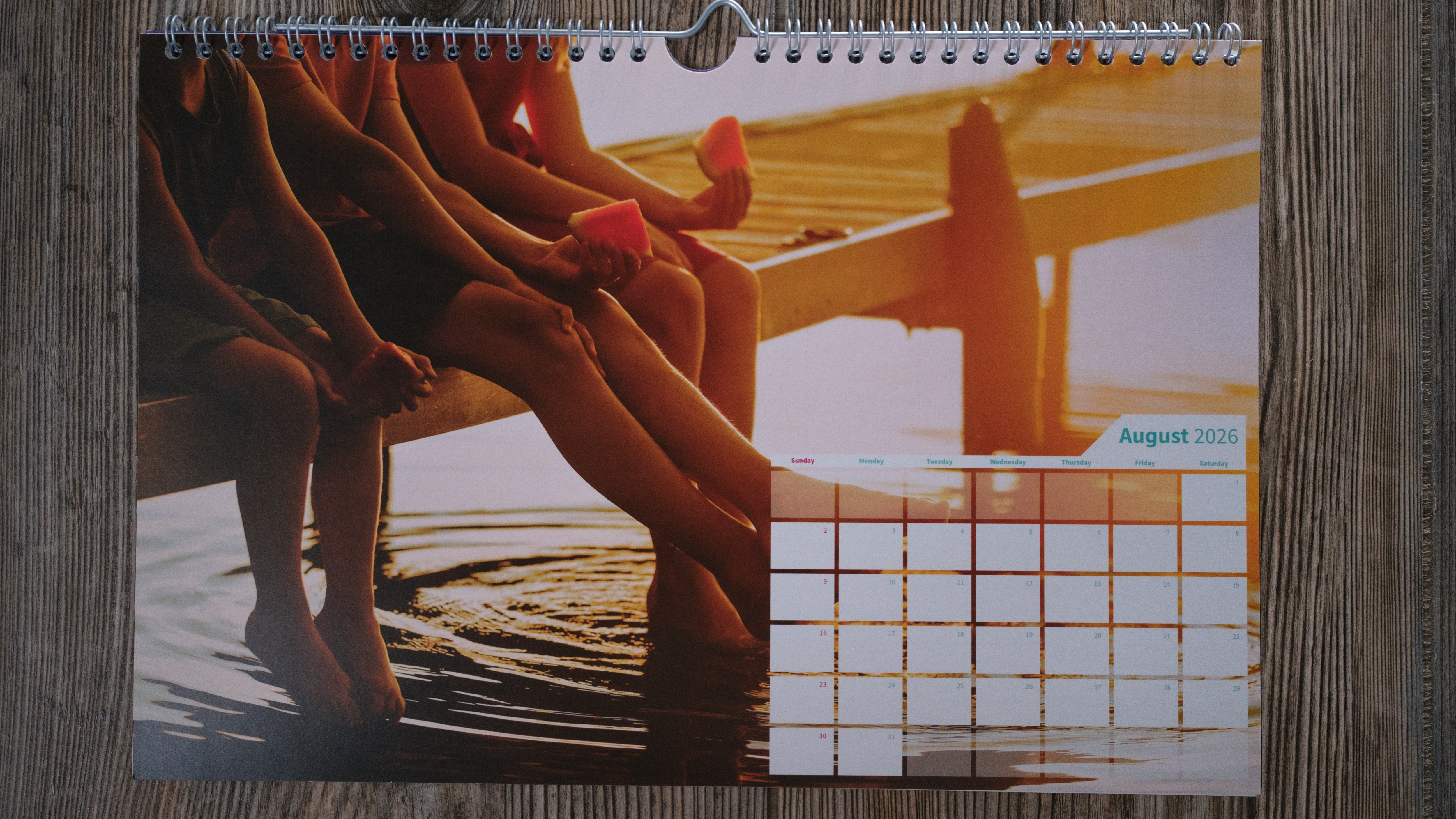 A wall calendar from Saal on a wood background