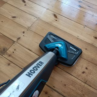 First person view of a Hoover steam cleaner being used on a wooden floor