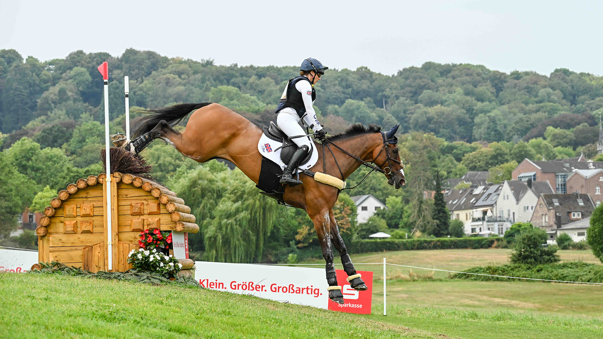 Laura Collett and London 52 clear a rolltop with a drop on landing during the cross-country phase at the Aachen 2026 eventing World Championships