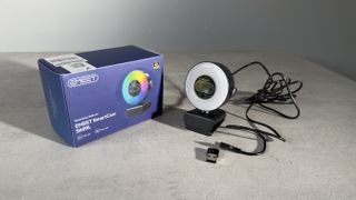 The EMEET SmartCam S600L webcam, USB cable and adapter displayed beside the retail box.