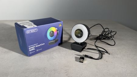 The EMEET SmartCam S600L webcam, USB cable and adapter displayed beside the retail box.