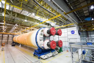 The 212-foot (65 meters) core stage of NASA's new megarocket, the Space Launch System, rolls out of the Michoud Assembly Building in New Orleans, Louisiana on Jan. 1, 2020 for transport to the Stennis Space Center in Bay St. Louis, Mississippi for a critical test.