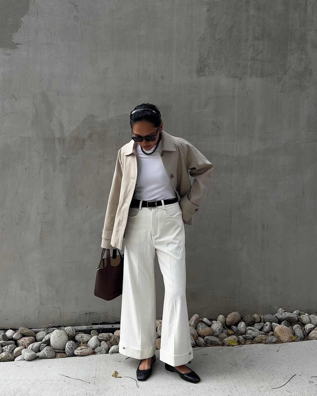 Dawn in white flare jeans and black ballet flats