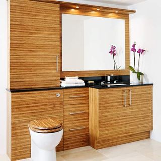 wooden bathroom with cabinets and drawers