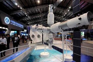 China is planning a 60-ton space station as the next step for its manned spaceflight program. The station, as shown here in an air show model, will consist of multiple modules arranged around central hubs much like Russia's Mir and the International Space