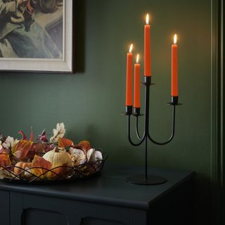 orange candles in a black candelabra