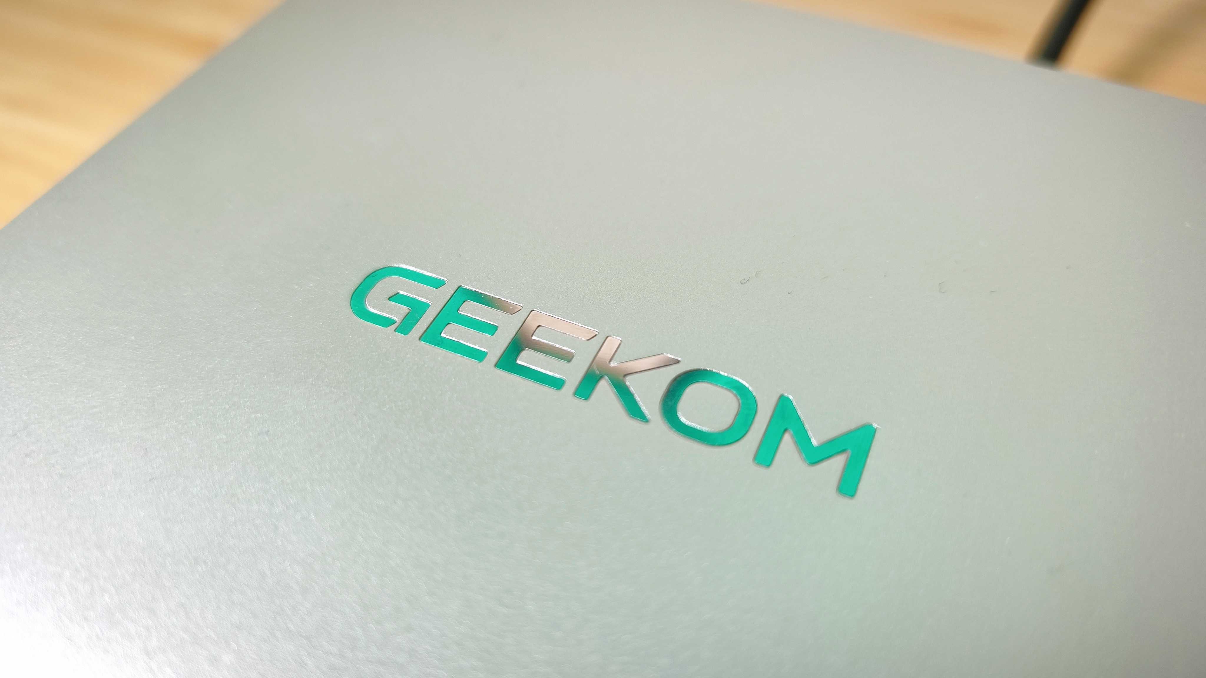 A silver Geekom A9 Max on a wooden desk