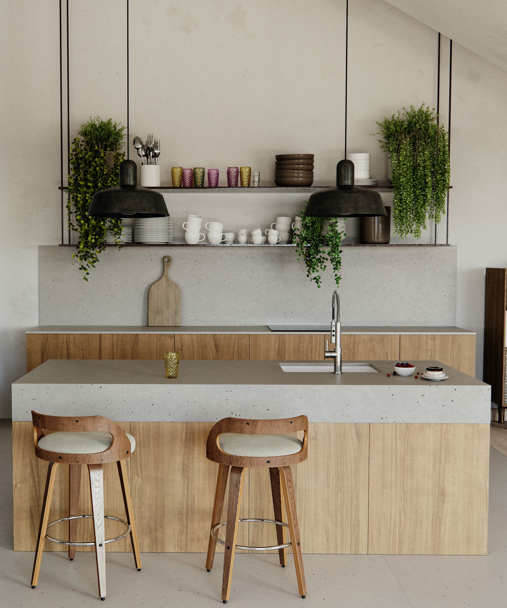 A small kitchen with light wood cabinets, a matching kitchen island, and light gray stone countertops. The walls have been painted warm white, and open shelving on the wall adds open storage. Two large black pendant lights sit above the island, and two mid-tone wood counter stools create an informal seating space around the island
