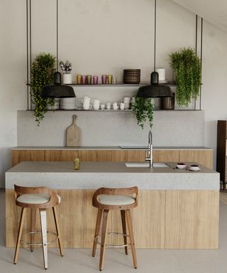 pale wood kitchen with grey composite quartz worktops and 2 wooden stools