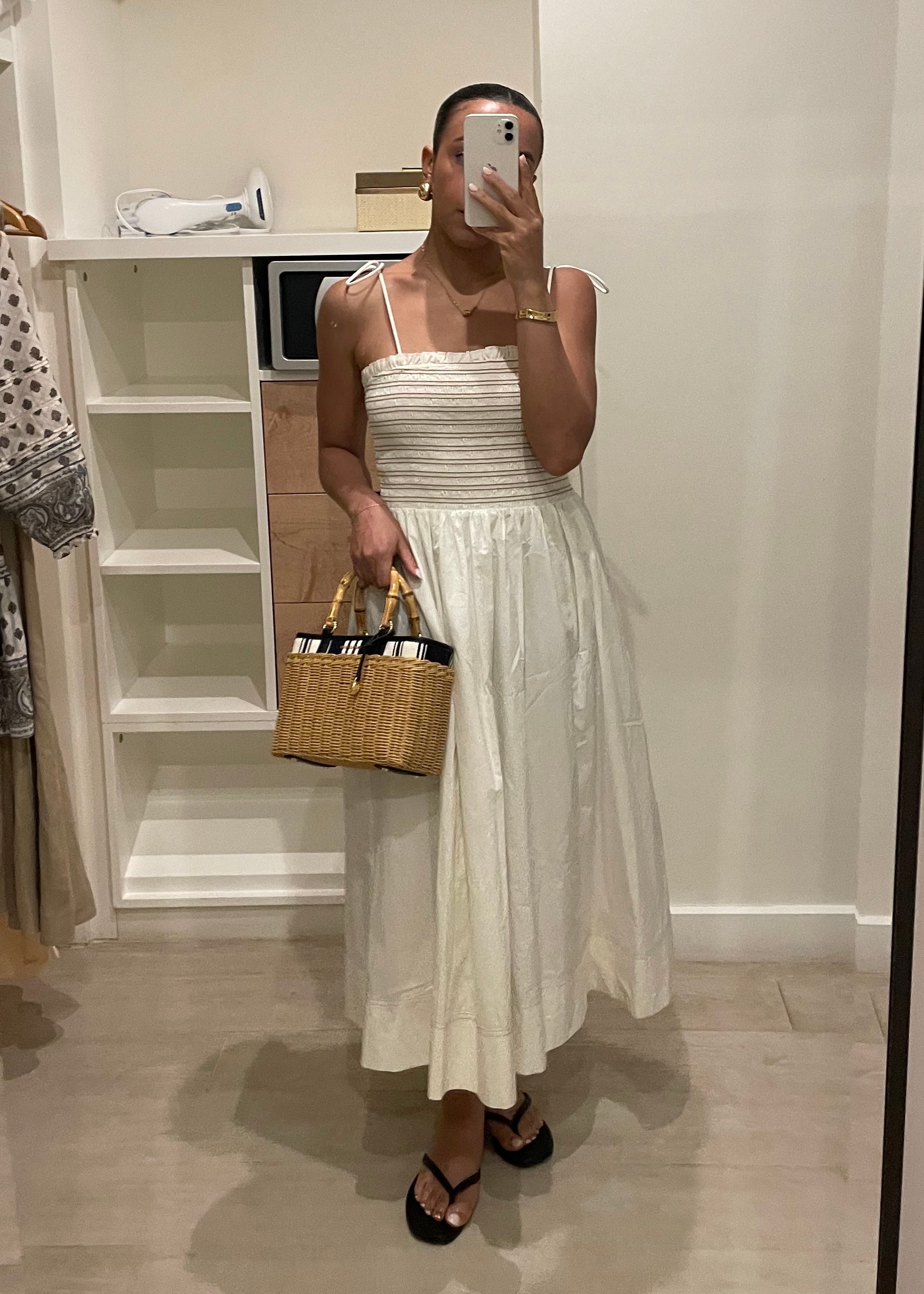 Lauren K. Tappan wearing a cream Veronica Beard dress, a Veronica Beard bag, and sandals