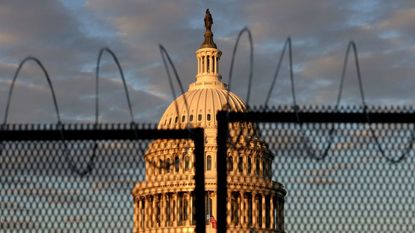 The Capitol building behind a fence.