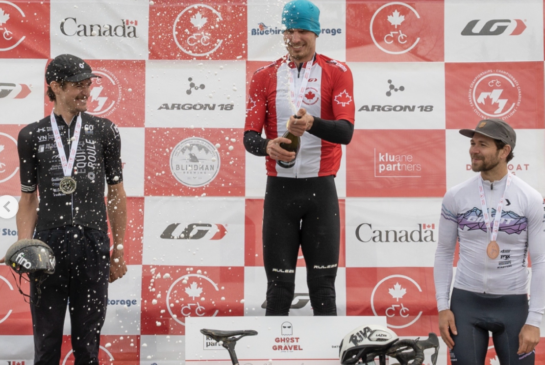 Adam Roberge celebrates on podium as elite men's winner 2024 Canadian Gravel National Championships