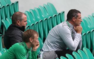 Jack Ross, right, sitting in the deserted stands during a pre-season friendly at Celtic