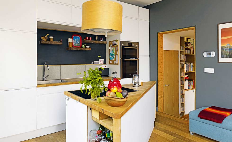 a small open plan kitchen with a triangular island