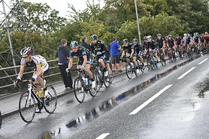 Team Sky's Ian Stannard, Bradley Wiggins riding through the rain followed by teammates Luke Rowe and Ben Swift