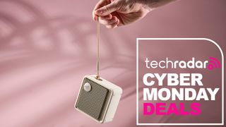 Person holding Edifer ES20 by strap alongside the words 'TechRadar: Cyber Monday deals'