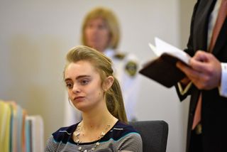 a medium shot of Michelle Carter sat in court
