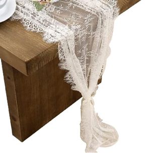 A lace table runner on a wooden table