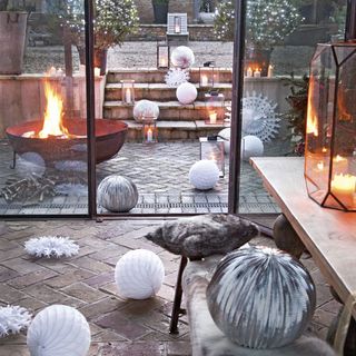 looking out to garden terrace with fire pit and christmas garden decorations