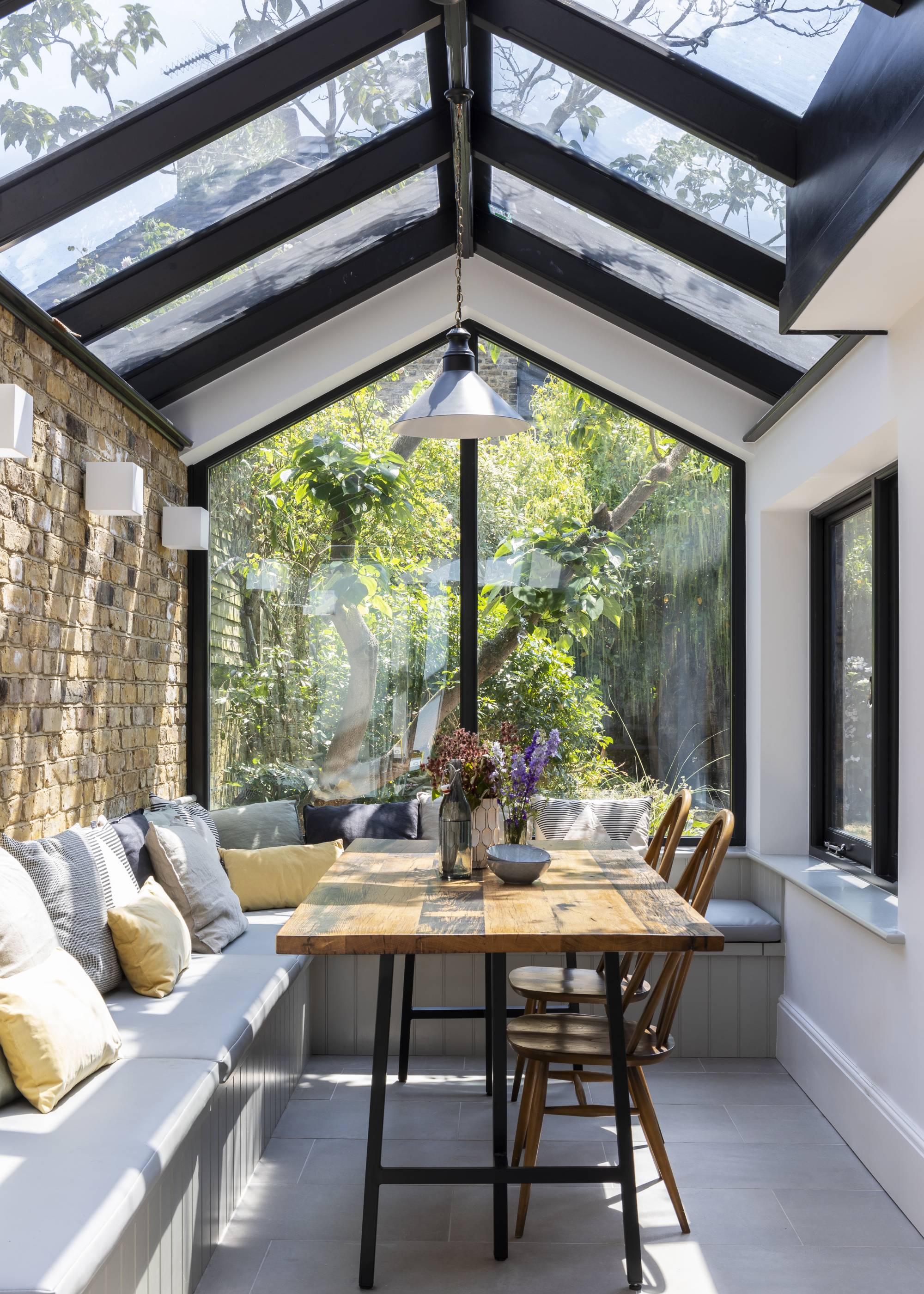 glass extension with pitched roof and built in dining area