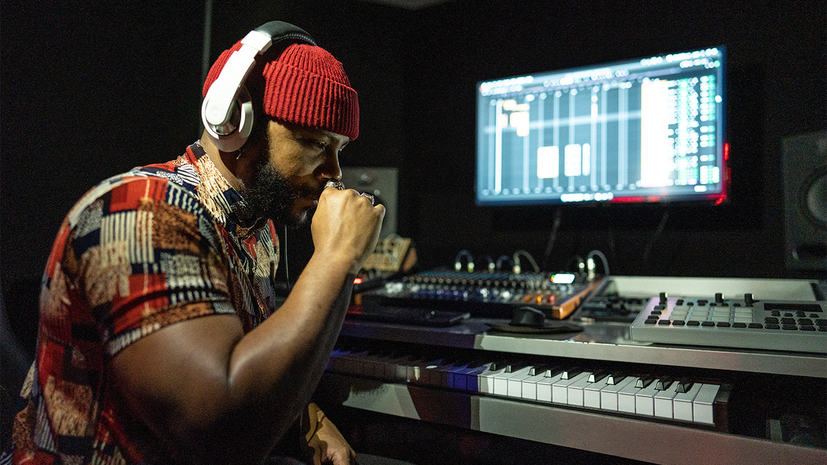 sneaky musician sitting at computer