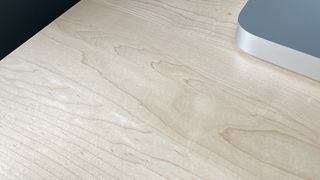 A close up of the wood grain of the Sway standing desk.