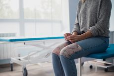 A woman waiting in a doctor's office.