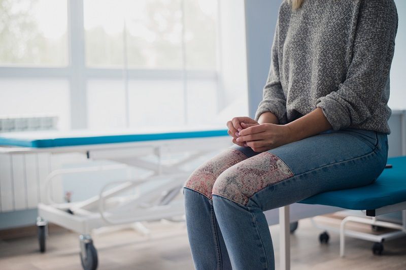 A woman waiting in a doctor&#039;s office.